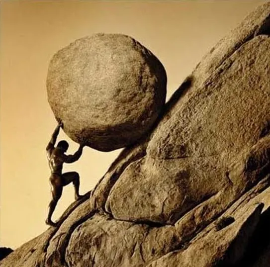man pushing  abolder up a hill