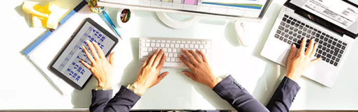 man with four arms working on several devices