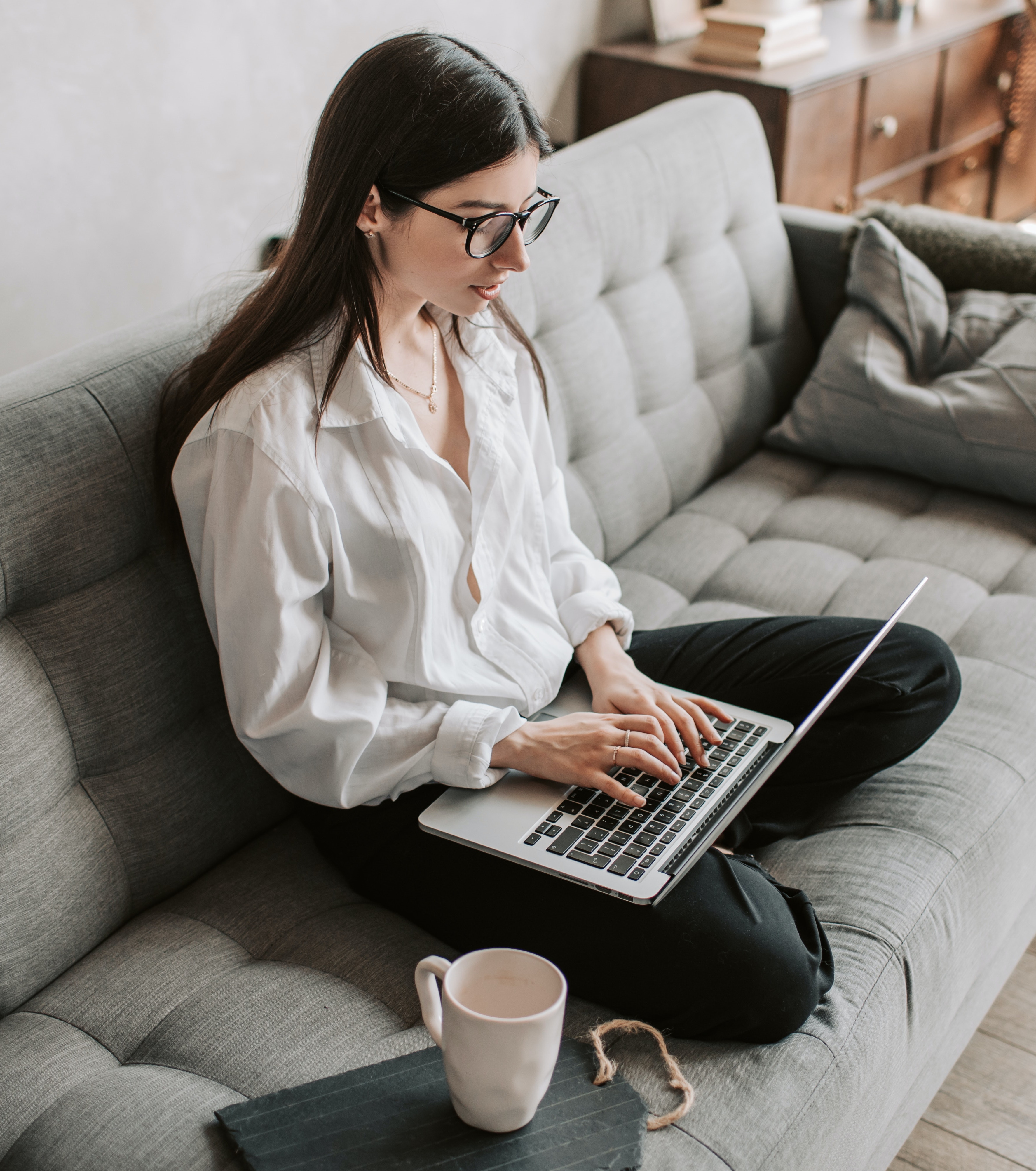 woman on couch on computer
