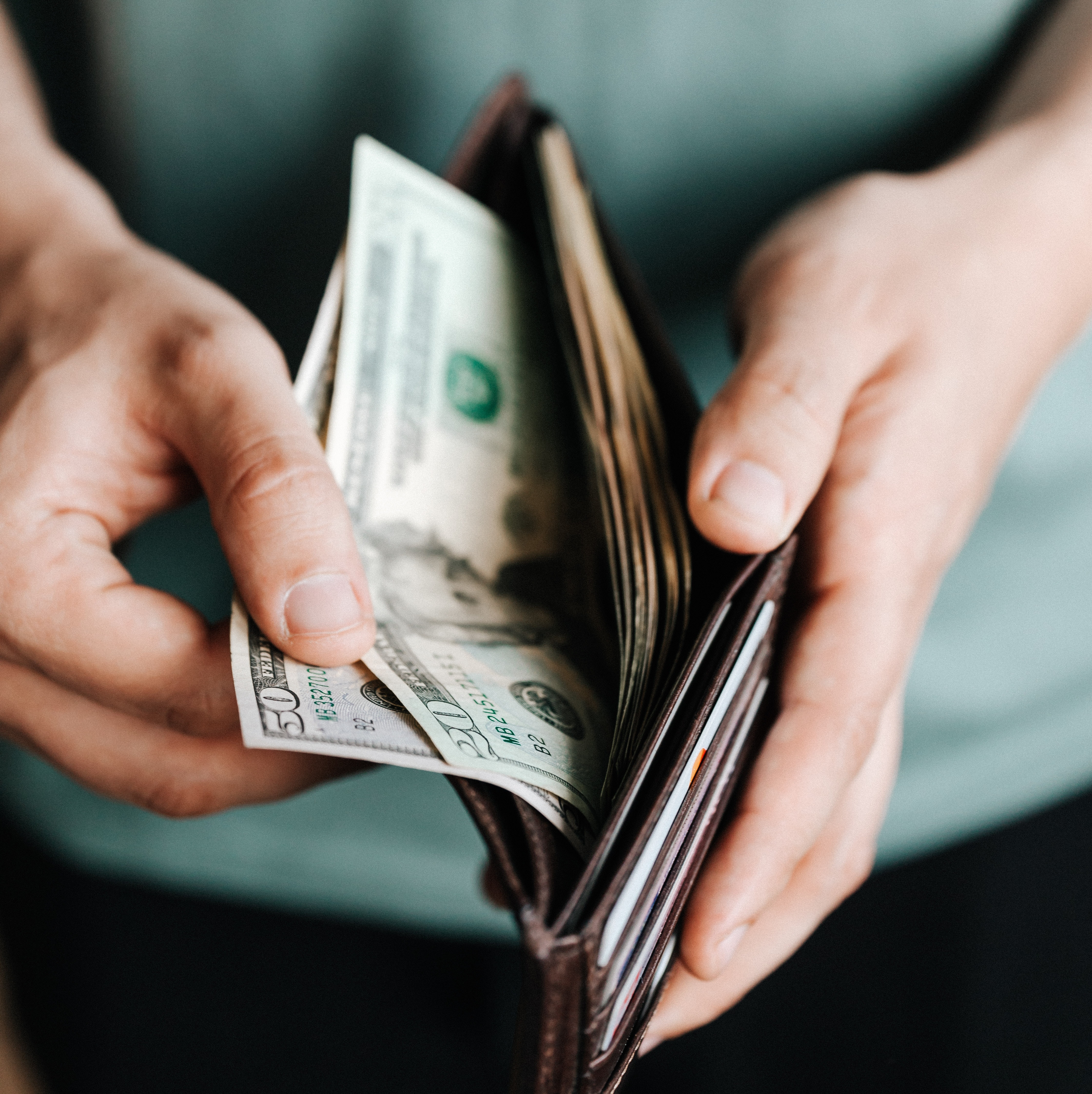 Man taking money out of wallet